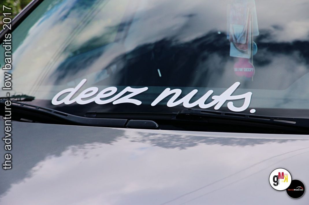Windschutzscheibe eines weißen Oldtimers mit "deez nuts"-Schriftzug bei The Adventure Low Bandits 2017