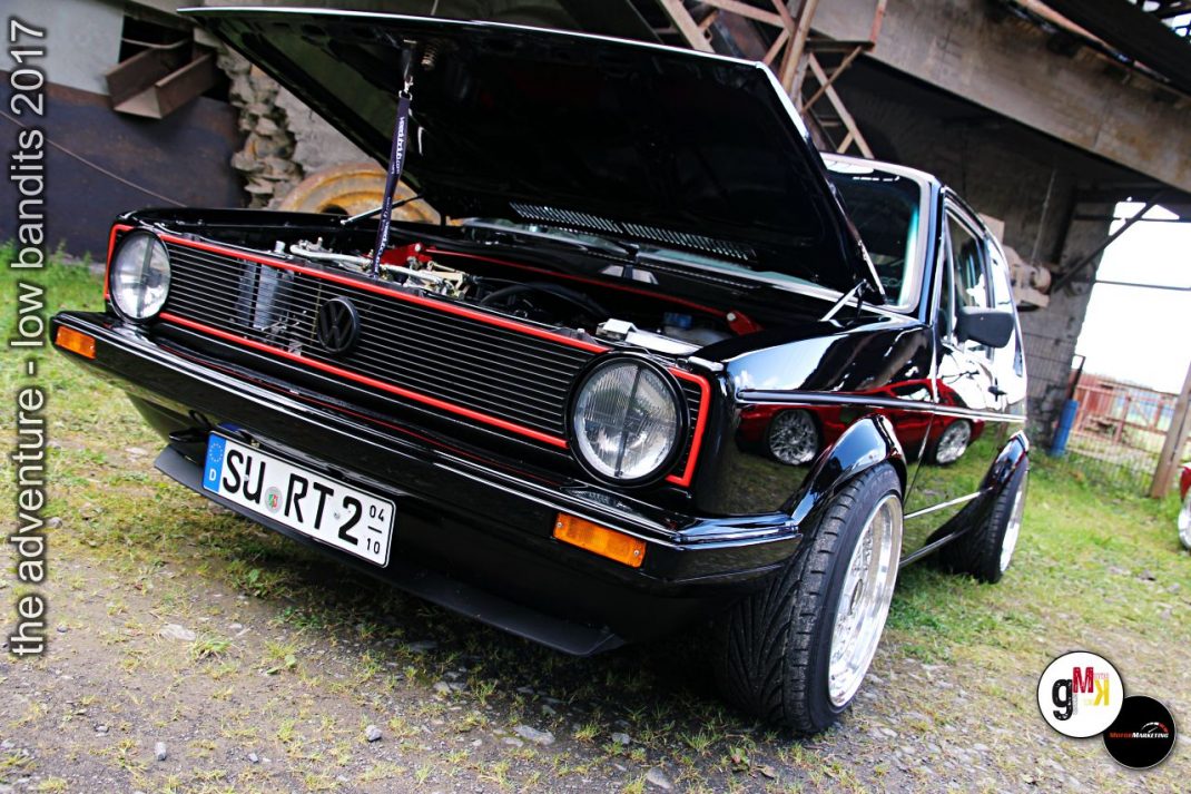 Schwarzer VW Golf mit offener Motorhaube und roten Zierleisten beim Tuning-Treffen Low Bandits 2017