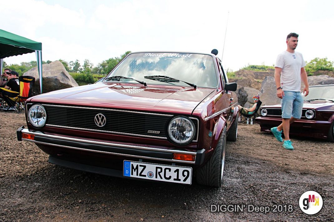 Roter VW Youngtimer mit charakteristischem Grill auf Treffen DIGGIN' Deep 2018 in der Eifel, Teilnehmer und weitere Fahrzeuge im Hintergrund