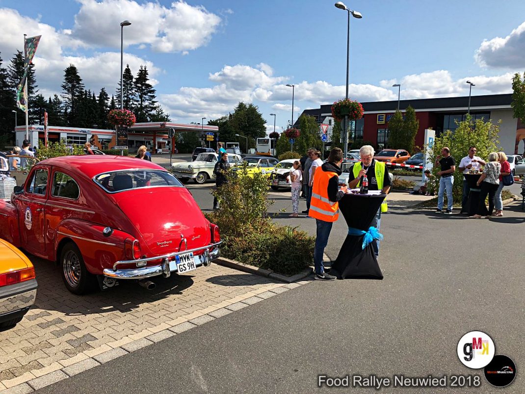 Roter Oldtimer-Limousine auf Parkplatz bei der Food Rallye Neuwied 2018, Besucher und Helfer in Warnwesten im Hintergrund