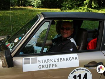 Fahrer in Oldtimer-Cabrio mit Starkenberger-Gruppe-Beschriftung bei der ADAC Oldtimerfahrt Hessen-Thüringen